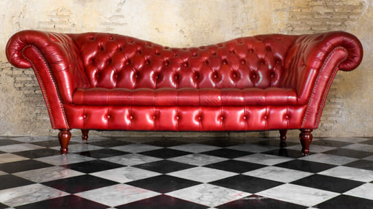 Canapé cuir rouge sur sol en marbre damier